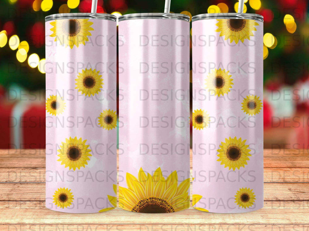 Pink tumbler with sunflowers and "DESIGNSPACKS" logo.