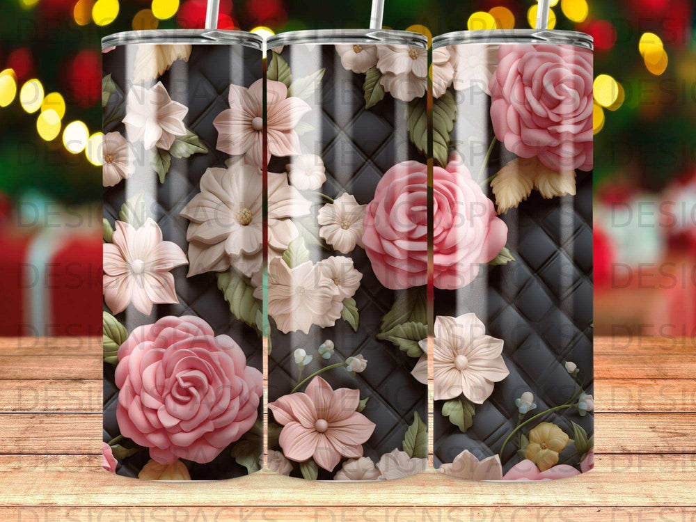 Floral tumbler with pink and white flowers on quilted black background.