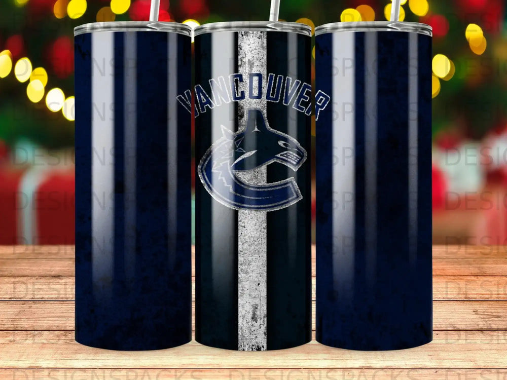 Vancouver Canucks logo on a dark blue striped tumbler with blurred bokeh lights.