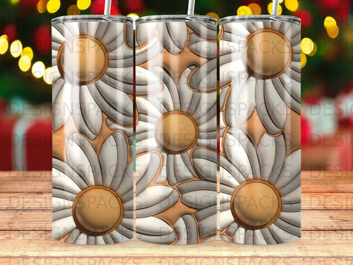 Daisy pattern on three metal tumblers with straws.