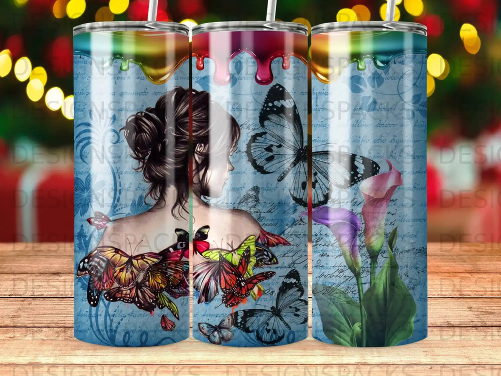 Tumbler with butterflies, flowers, and watercolor splatters on a blue, script background.
