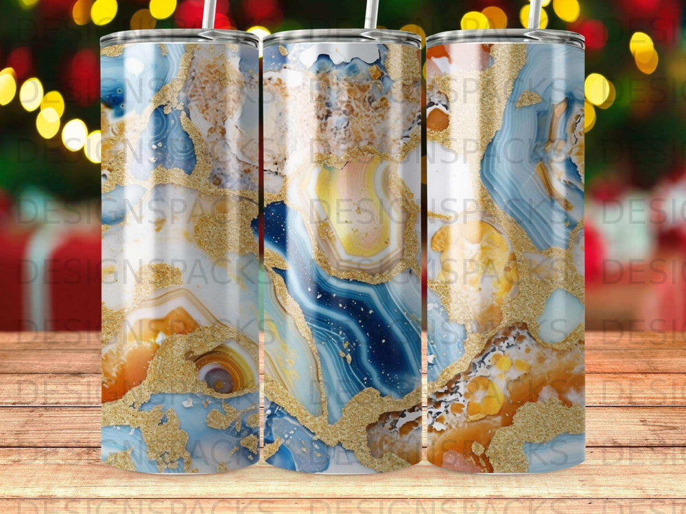 Three tumblers with blue, gold, and white agate-like patterns.