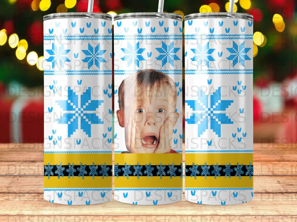 Child with surprised expression on a tumbler with blue snowflake and yellow stripe pattern.