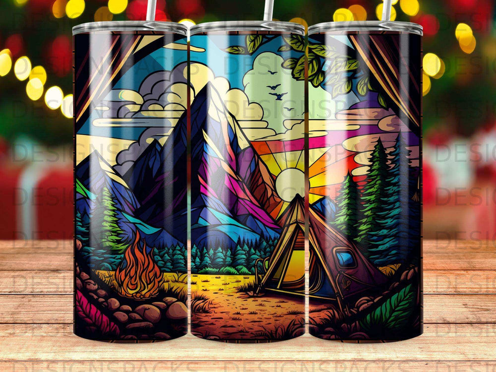 Tent and campfire at sunset in a colorful mountain landscape.