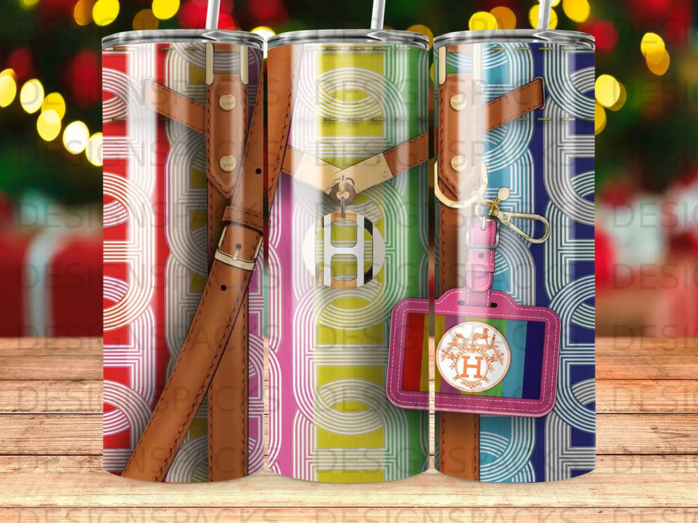 Three tumblers featuring a colorful geometric pattern and leather strap accents.