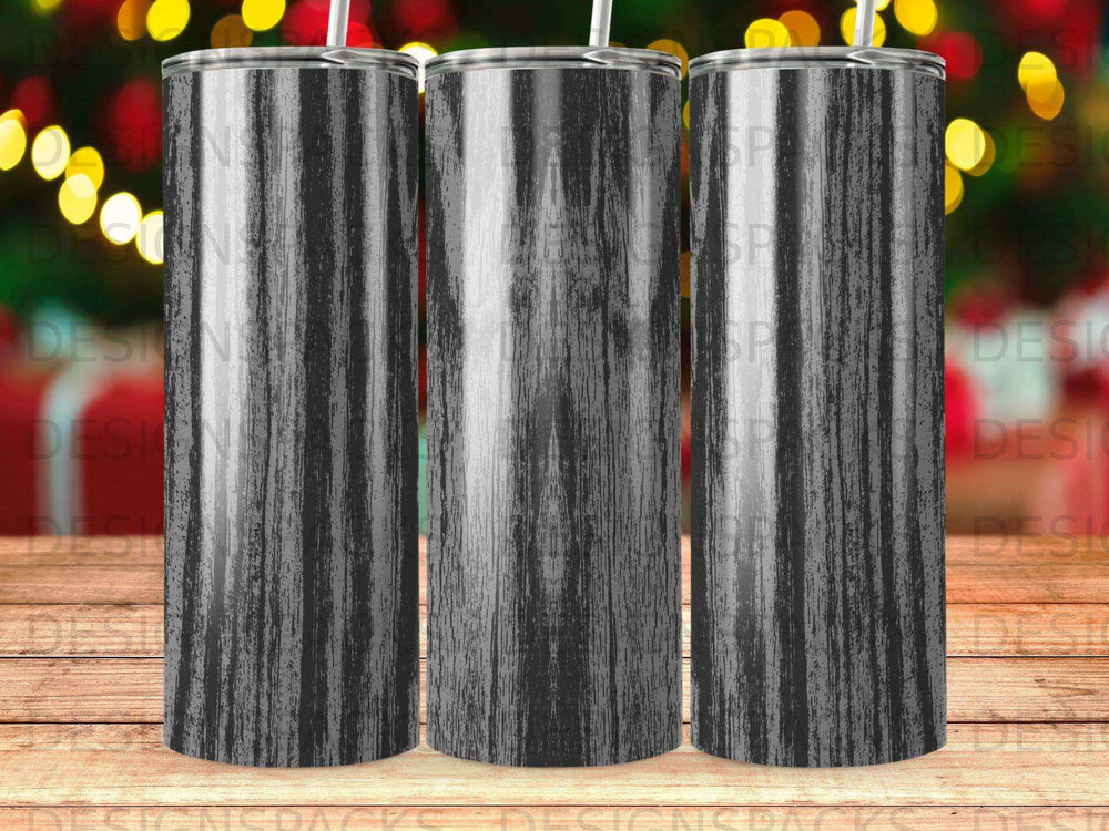 Three blank tumblers with a distressed dark wood grain pattern and straw.