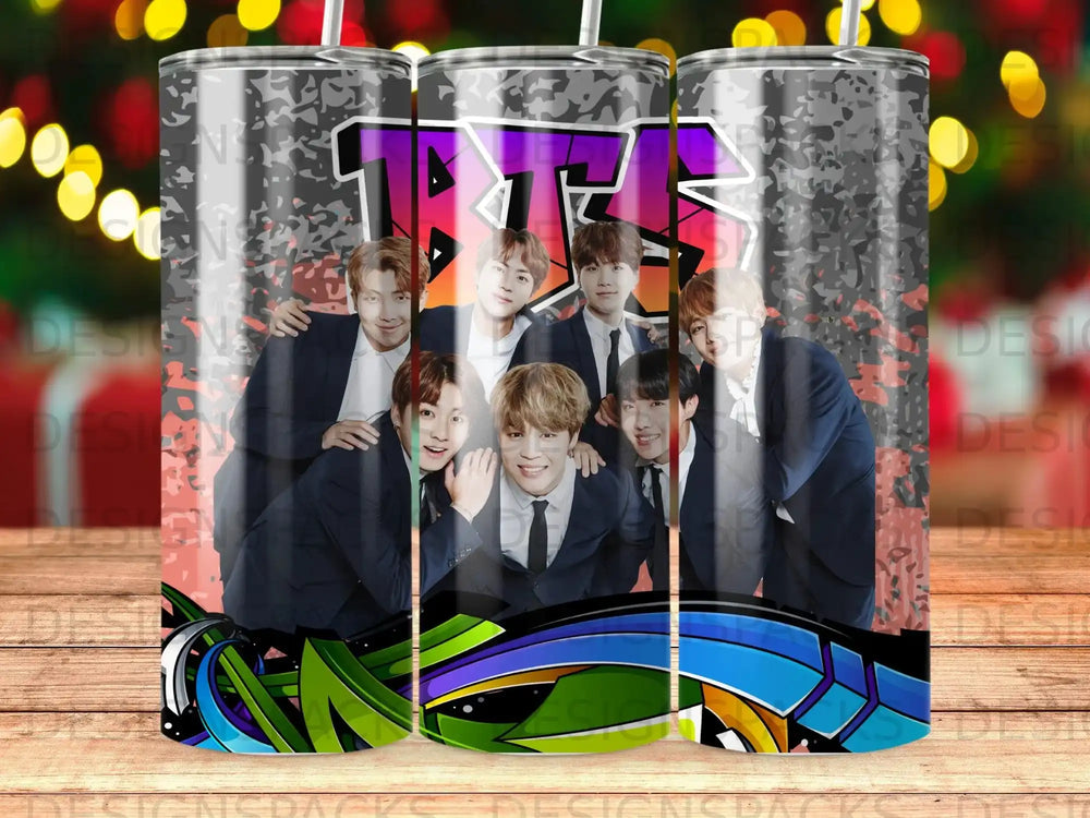 BTS members posing in suits with graffiti art on a tumbler.