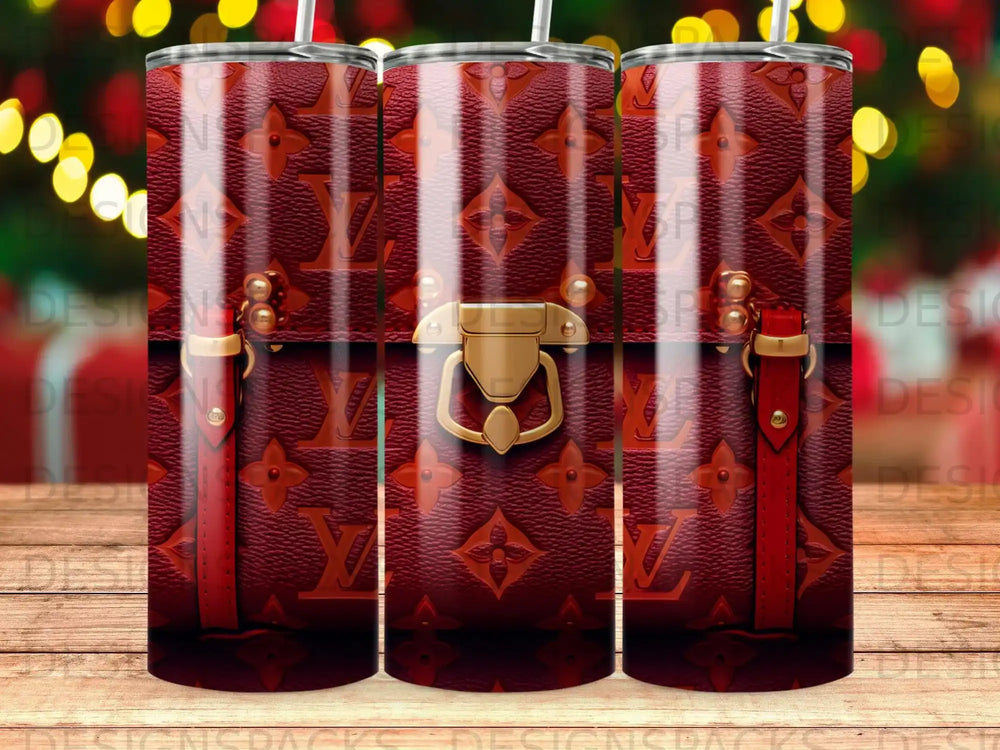 Three tumblers with a red Louis Vuitton monogram pattern and gold hardware accents.