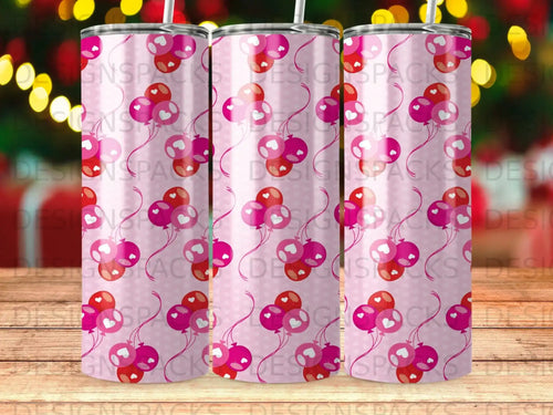 Pink and red balloons with hearts pattern on a tumbler.