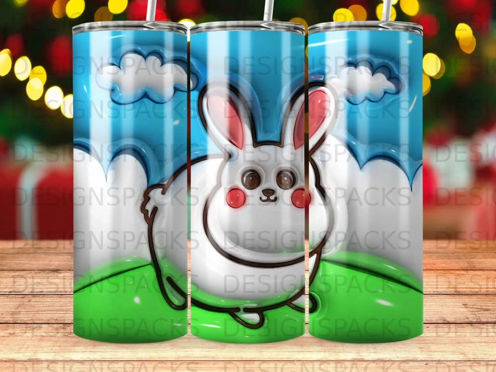 White bunny with blue sky and green grass pattern on a tumbler.