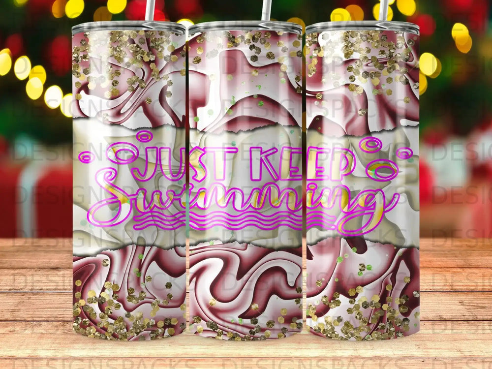 Tumbler with swirling pink and white design, gold glitter, and "Just Keep Swimming" text.