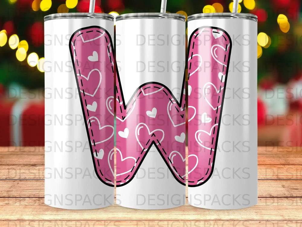 Pink letter W with hearts pattern on white tumbler.