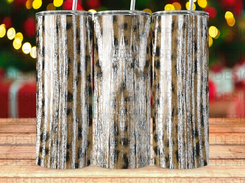Three tumblers with a distressed leopard print design and a bokeh background.