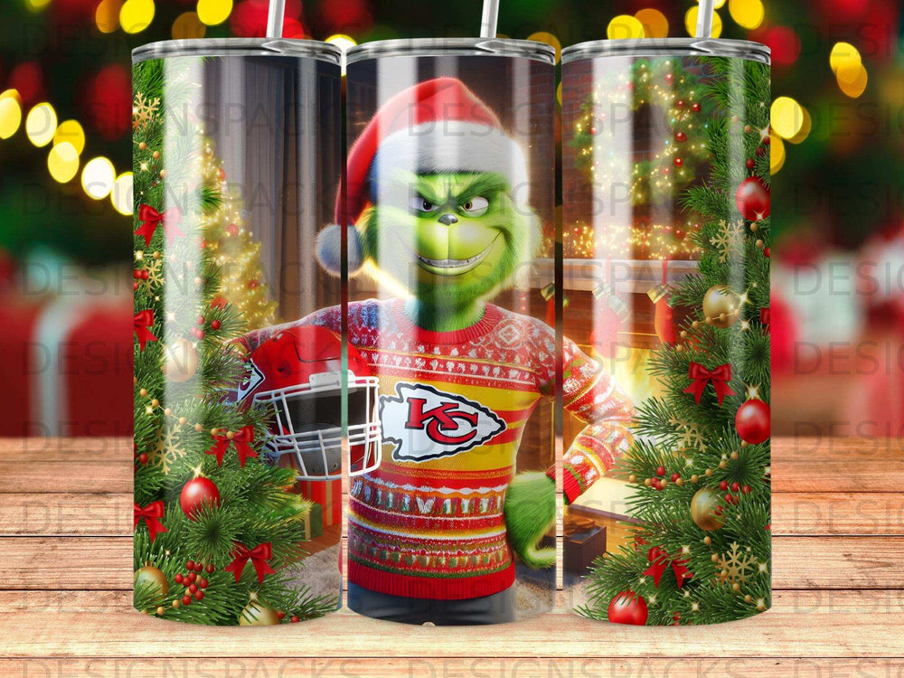 The Grinch in a Santa hat holds a Kansas City Chiefs helmet, wearing a festive sweater.