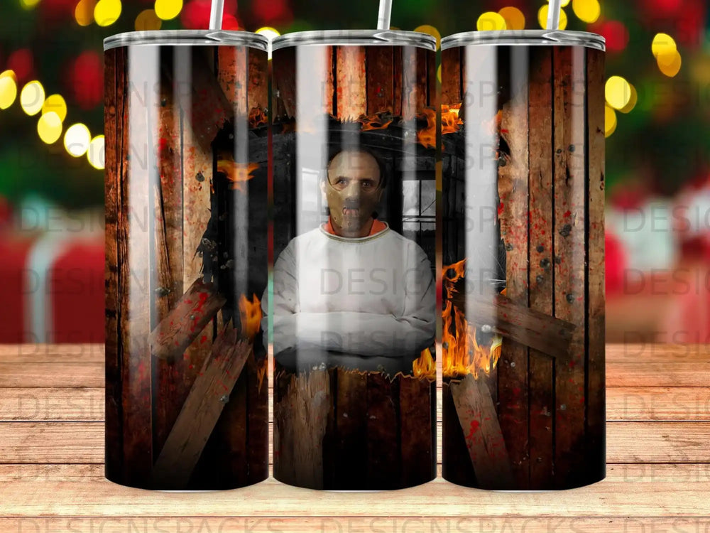 Man in Hannibal Lecter mask with fiery background on a tumbler.