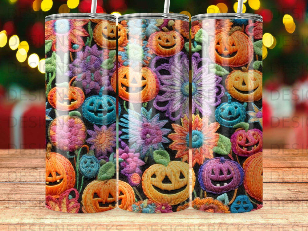 Three tumblers with Halloween pumpkins and floral patterns.