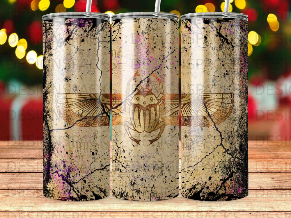 Three tumblers with Egyptian scarab beetle and hieroglyphic designs on distressed background.