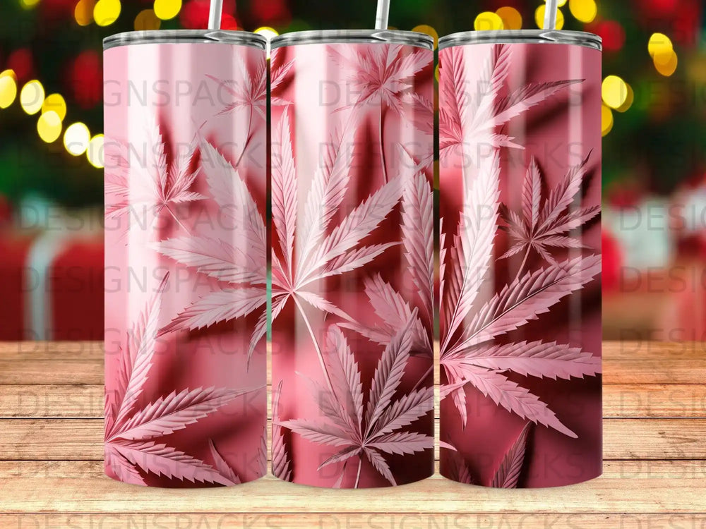 Pink cannabis leaf pattern on three tumblers against a blurred bokeh background.