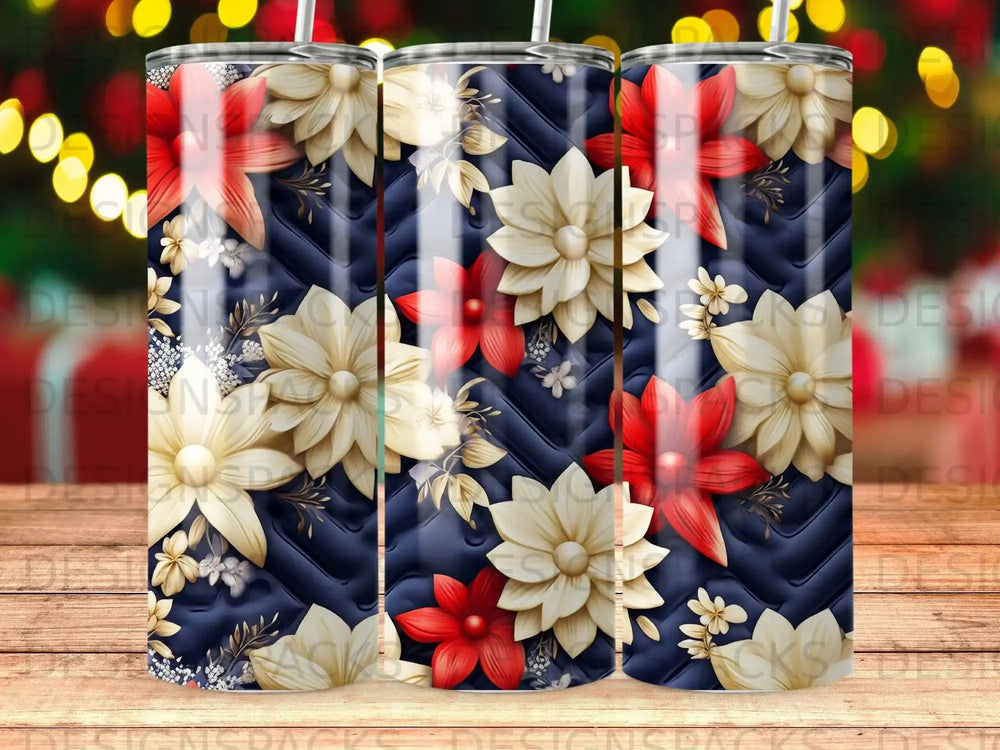 Three tumblers with a dark blue quilted background and red and cream floral designs.