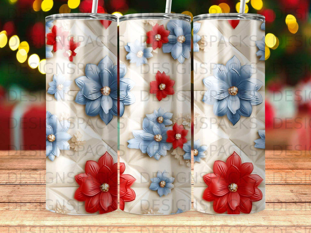 Three tumblers with red and blue flowers on a quilted background.