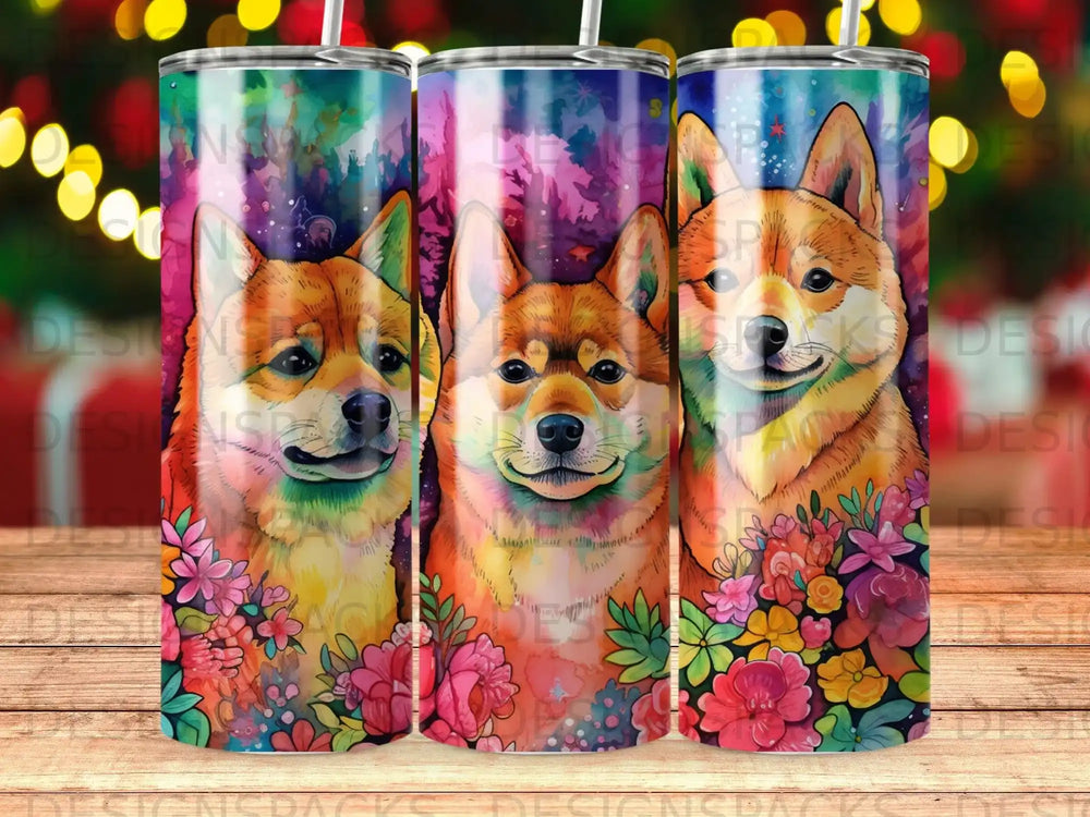 Three Shiba Inu dogs with colorful floral accents on a cylindrical tumbler.