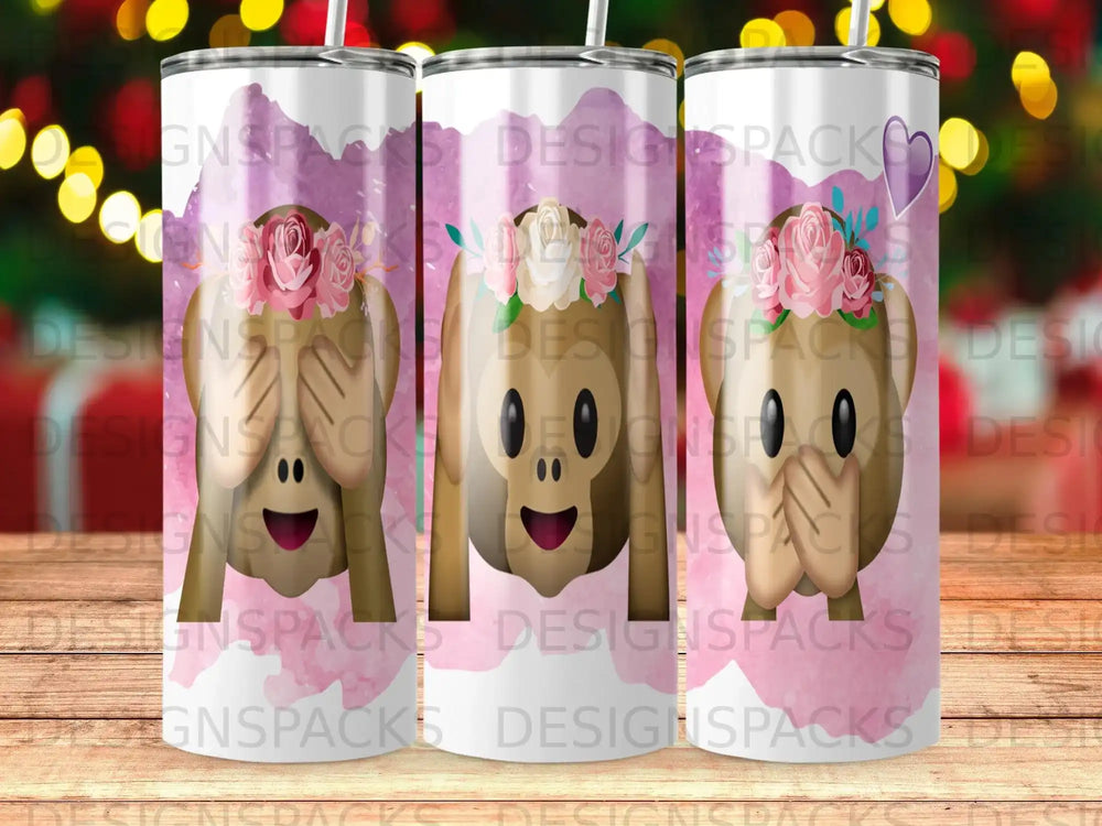 Three tumblers with monkey emojis, flowers, and "DESIGNSPACKS" text.