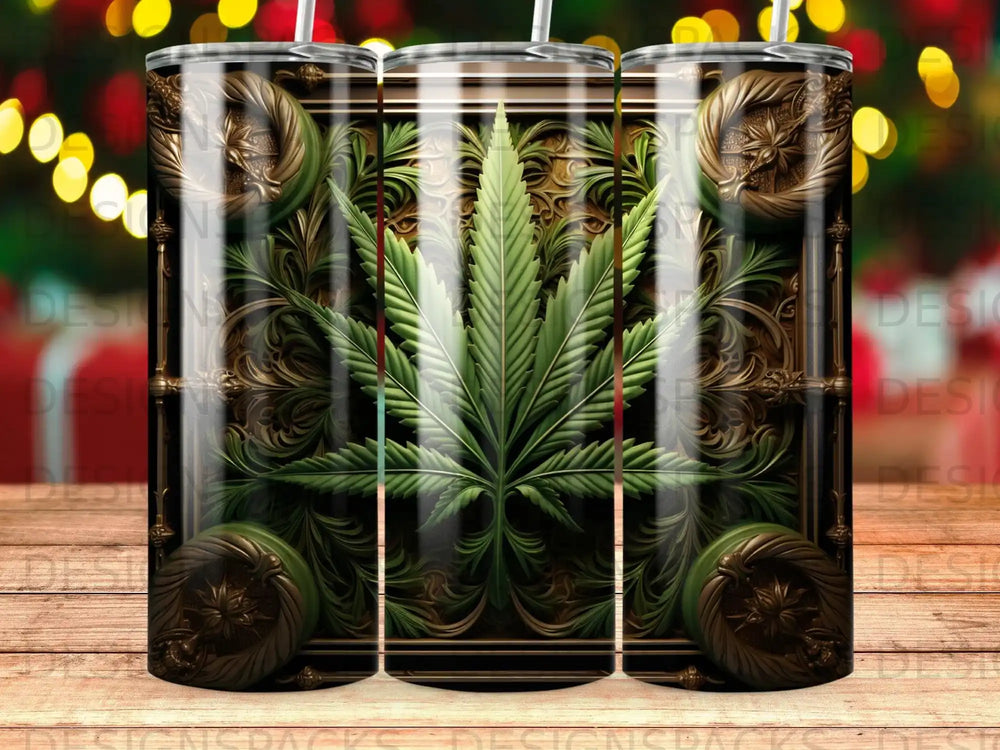 Cannabis leaf in ornate gold and green frame, three tumblers on wooden surface.