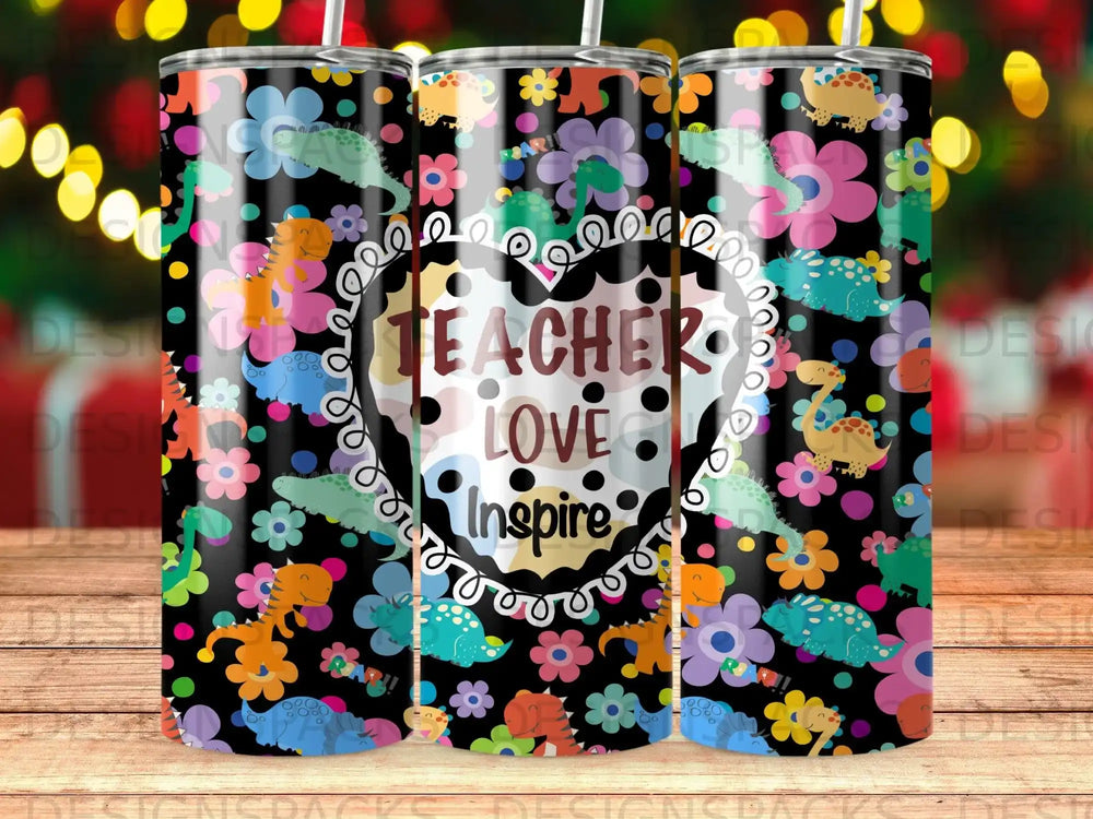 Black tumbler with dinosaurs, flowers, and "Teacher Love Inspire" text.