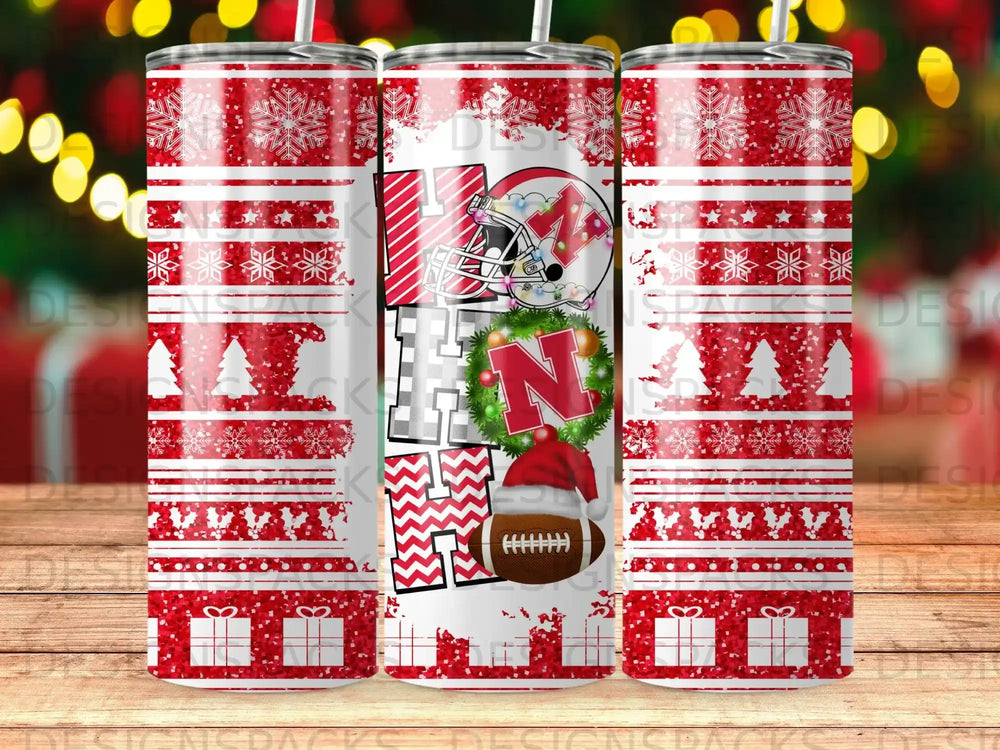 Red and white snowflake pattern tumbler with a large "H" and "N" with a football.
