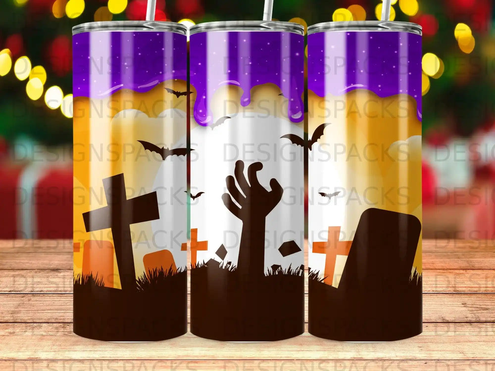 Halloween tumbler with zombie hand and graves against purple sky.