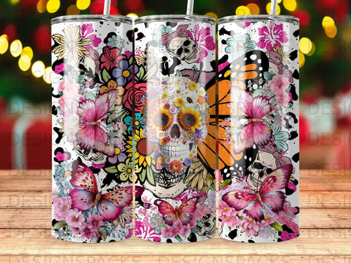 Skull with butterfly and floral pattern on a tumbler.