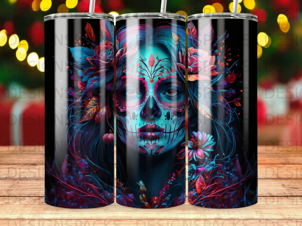 Day of the Dead skull art with flowers and neon accents on a tumbler.