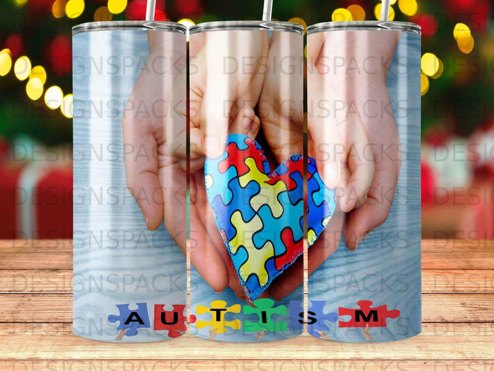 Tumbler with a colorful puzzle heart and "AUTISM" text.