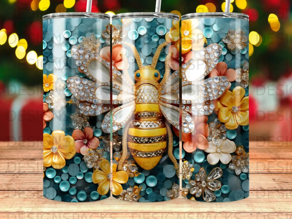 Glittering bee and floral pattern on a cylindrical tumbler with blue speckled background.