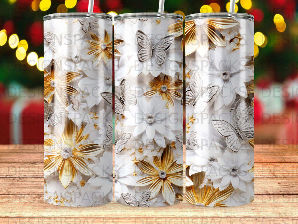 Three tumblers with white flowers and silver butterflies on wood.