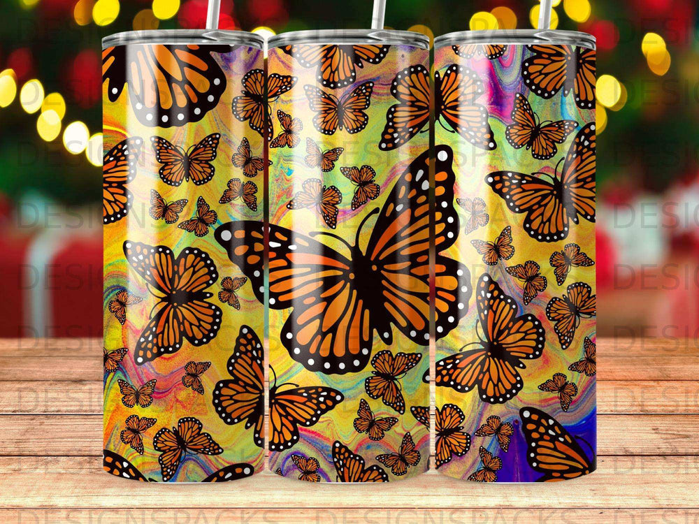 Tumbler with a vibrant monarch butterfly pattern on a yellow background.