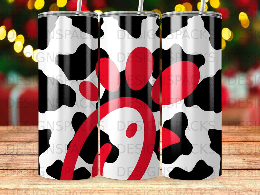 Cow print tumbler with a red and white logo in the center.