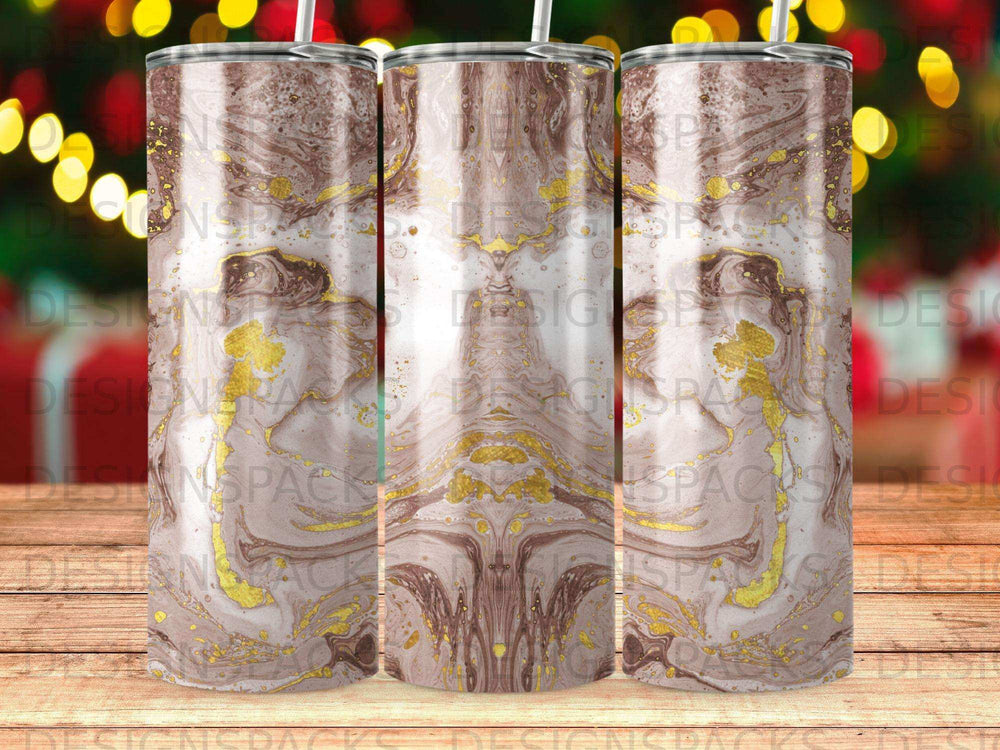 Brown and gold marble pattern tumbler with straw on blurred bokeh background.