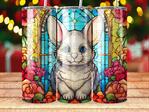 Stained glass rabbit with floral border on a tumbler.