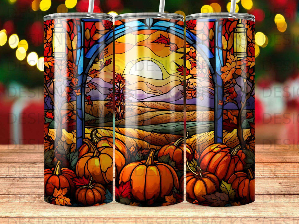 Stained glass window with pumpkins and autumn leaves, bright sun behind a landscape.