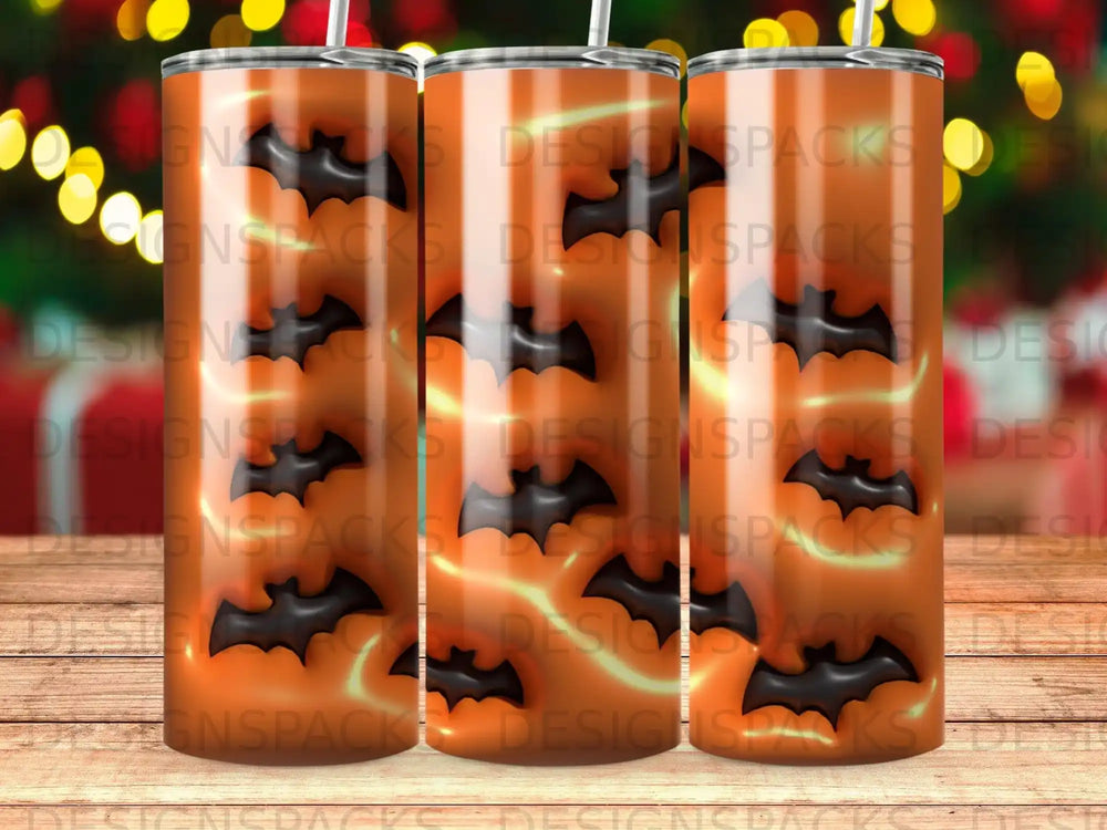 Orange tumbler with repeating black bat pattern and bokeh lights.