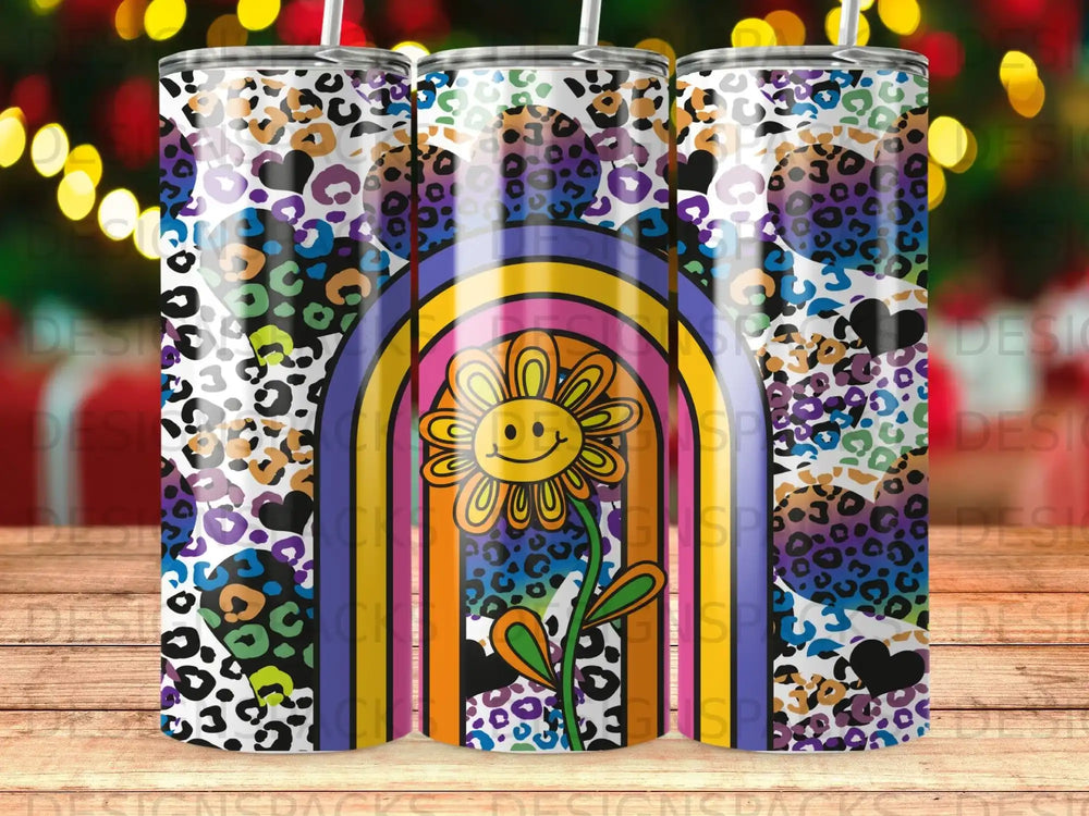 Colorful rainbow tumbler with a smiling flower and leopard print pattern.