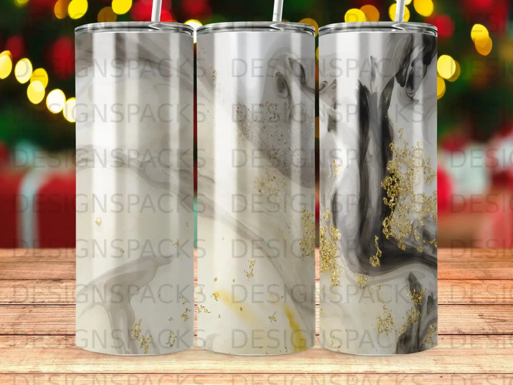 Three tumblers with marble and gold glitter designs.