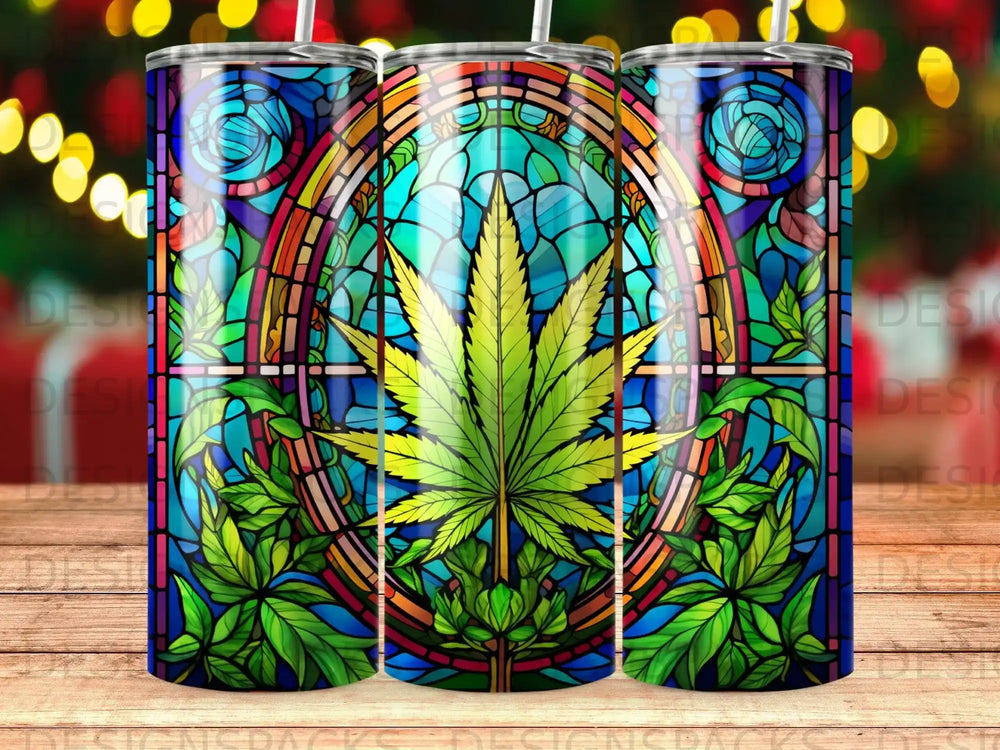 Stained glass tumbler featuring a central cannabis leaf with vibrant blue and green floral accents.