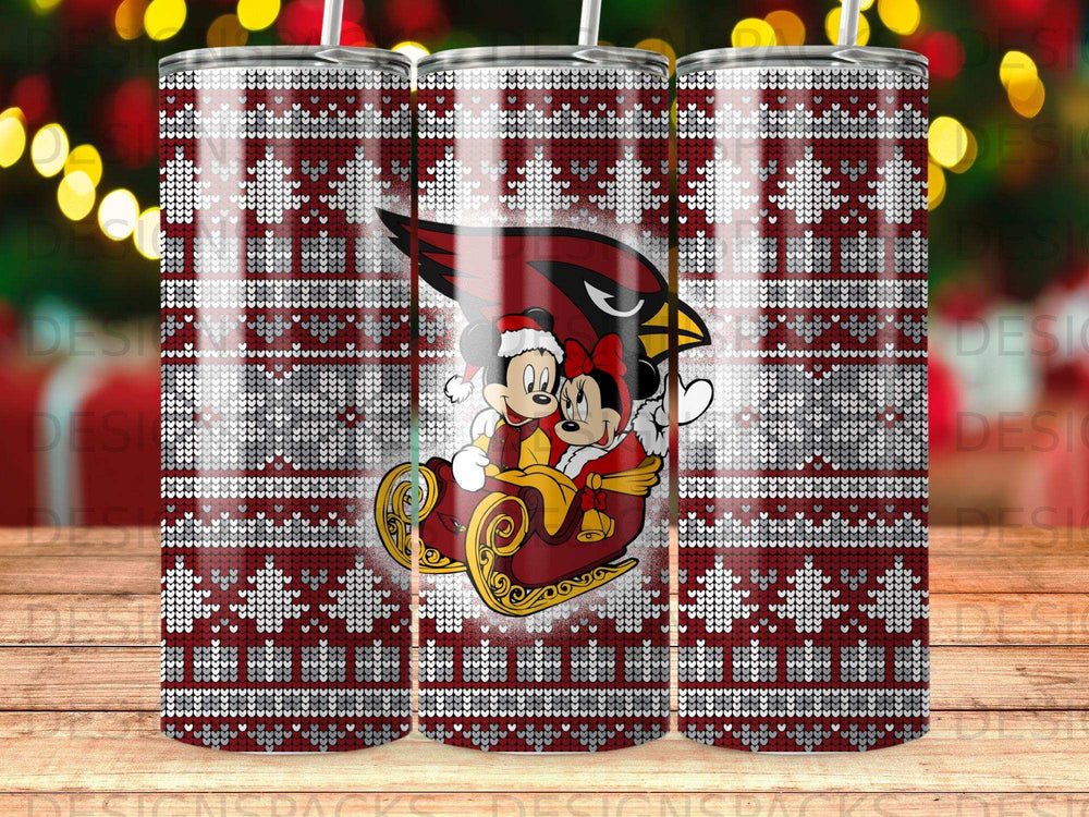 Mickey and Minnie Mouse in a sleigh with a Cardinals logo, on a patterned tumbler.
