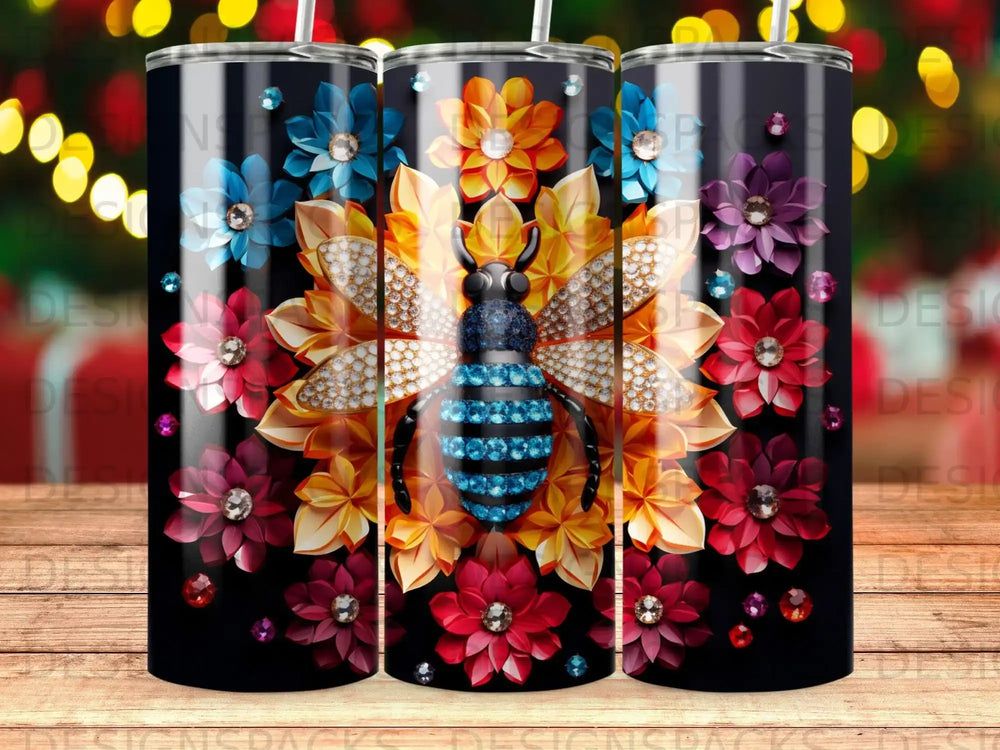 Black tumbler with a jeweled bee surrounded by colorful floral designs.