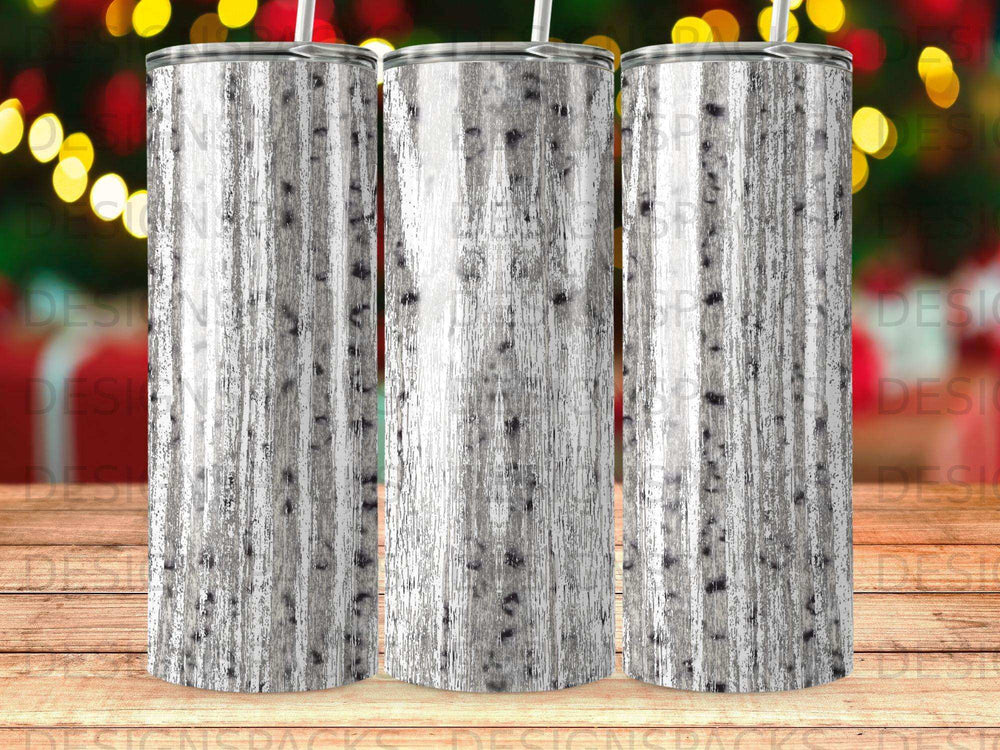 Three tumblers with a white birch bark pattern against a bokeh background.