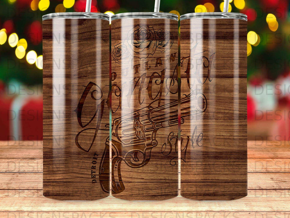 Tumbler with "Detroit Glam Style" text and engraved revolver on wood grain background.