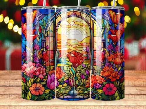 Stained glass tumbler with vibrant floral and sunset motif.