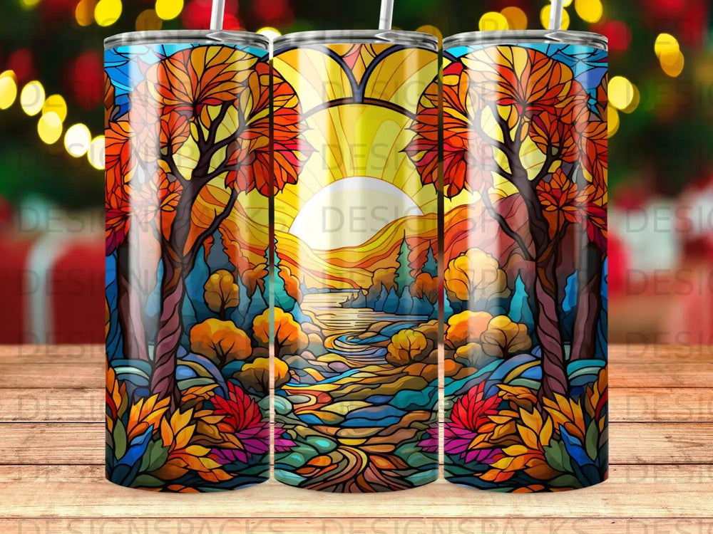Stained glass tumbler with autumn forest scene and a river.